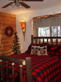 a bed room with a neatly made bed and christmas decorations