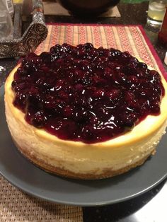 a cheesecake with blueberry topping on a plate