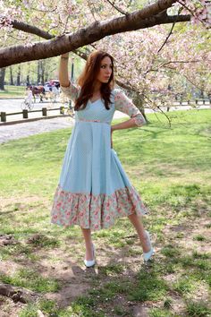 Our Storybook Farm Dress is simply dreamy! In gorgeous shades of aqua and mauve pink, it has a flattering empire bodice and is midi length with a sewn in petticoat. Fully lined and with contrasting trim throughout. Made from 100% cotton. Sewn in the U.S.A. Made in USA100% CottonFully LinedMidi DressBack Zipper3/4 Sleeve Light Blue Ruffled Midi Dress For Garden Party, Light Blue Midi Dress With Fitted Bodice, Light Blue Fitted Bodice Midi Dress, Spring Midi Dress With Fitted Bodice For Dressmaking, Blue Maxi Dress With Fitted Bodice For Garden Party, Blue Midi Dress With Fitted Bodice For Garden Party, Light Blue Midi Dress For Spring Garden Party, Light Blue Midi Dress For Garden Party In Spring, Blue Empire Waist Dress With Ruffles