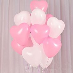 pink and white heart shaped balloons in a vase