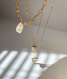 An edgy, yet classic piece that can easily be worn by itself to complete a look. Dress it up or dress it down. This necklace is 15.5 inches long. This is made with a cultured pearl and gold filled materials. It is safe to wear in water, but should stay away from chemicals like soaps, lotions, and perfumes. Minimalist Gold Pearl Necklace With Chain, Everyday Gold Pearl Charm Necklaces, Gold Minimalist Pearl Necklace For Layering, Minimalist Gold Pearl Necklace For Layering, Minimalist Gold Charm Necklace With Pearl, Everyday Gold Pearl Chain Necklace, Gold Pearl Necklace For Layering, Minimalist Gold Pearl Charm Necklaces, Everyday Gold Pearl Drop Necklaces