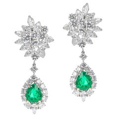 A pair of Van Cleef & Arpels AGL Certified Colombian Emerald and Diamond Day and Night Earrings made in Platinum. The pear-shaped mixed-cut emeralds weigh appx. 2.75 cts and 3.30 cts. The diamonds, round brilliant-cut, pear-shape, and marquise-cut diamonds, weigh appx. 17.90 cts. The AGL certificate states that the emeralds are from Colombia with the traditional treatment of minor clarity enhancement. The earrings also have a Letter of Authenticity. The length is 2 1/8 inches, and the drops are detachable to make either a pendant or to have the diamond day earrings. Signed and numbered. Diamond Earrings Harry Winston, Harry Winston Diamond, Emerald Diamond Earrings, Van Cleef & Arpels, Vintage Drop Earrings, Platinum Earrings, Harry Winston, Diamond Dangle Earrings, Colombian Emeralds