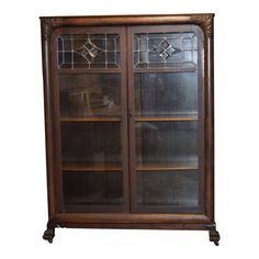 an old wooden bookcase with glass doors