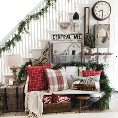 a living room filled with lots of furniture and christmas decorations on top of the wall