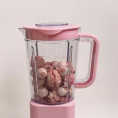 a pink blender filled with lots of beads