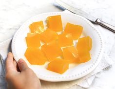 a white plate topped with cut up pieces of fruit