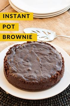 a chocolate cake sitting on top of a white plate with the words instant pot brownie