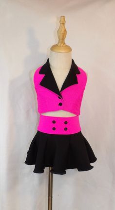 Neon pink halter vest with black collar with black circle skirt Your toddler will look absolutely precious in this neon pink halter vest with a black collar and matching circle skirt.  This outfit is both fashionable and practical, ensuring your little one is comfortable and stylish.  Perfect for playdates, parties, or just a day of fun, this outfit is sure to be a hit! This outfit is a perfect gift for your fashionable girl. DUE TO THE NATURE OF THIS BEING A HANDMADE ITEM, NO REFUNDS OR EXCHANGES ON OUR ITEMS. PLEASE ENSURE YOU MEASURE YOUR CHILD FOR THE CORRECT FIT.  ALL ITEMS ARE CUSTOM MADE TO YOUR SPECIFICATIONS. UNFORTUNATELY FABRICS CHANGE AND GO OUT OF STOCK. I DO MY BEST TO REPLACE IT WITH SOMETHING SIMILAR, BUT IT WILL NOT ALWAYS BE THE SAME. IF YOU NEED SOMETHING VERY SPECIFIC P Black Circle Skirt, Pretty Dance Costumes, Halter Vest, Black Circle, Girls Clothing Sets, Clothing Sets, Circle Skirt, Dance Costumes, Girls Clothing