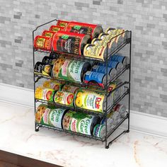 three tiered spice rack with spices and seasonings on the counter in front of a tiled wall