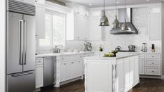 a large kitchen with white cabinets and stainless steel appliances in the center, along with wooden flooring