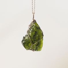 💎 Natural Moldavite Elegantly Wire-Wrapped in Sterling Silver 💎  Moldavite, a celestial gemstone, holds profound spiritual significance. Its transformative energy connects with the heart chakra, promoting love and compassion. This stone of dreams and intuition guides seekers on a spiritual journey, revealing hidden truths and higher wisdom. Through meditation, Moldavite opens doors to the divine, offering a powerful tool for spiritual growth. Embrace Moldavite as a cosmic key to unlock the mys Moldavite Pendant, Hidden Truths, Moldavite Jewelry, Natural Gemstone Jewelry, The Divine, Heart Chakra, Spiritual Journey, Spiritual Growth, Bookstore