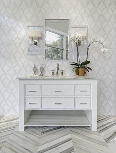 a white bathroom with two sinks and mirrors