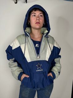 Starter vintage 3/4 zip nylon jacket. Winter game days require warmth and sportsmanship. This paneled and padded jacket has a hood, front zip pockets, elastic waistband, elastic cuffs, and a side half zip. The back features a giant star in honor of the cowboys, and a small embroidered patch with star and "cowboys" is also on the front. Product Measurements: See the Measurement Guide in the photo carousel. Shoulder: 26" Chest: 48" Waist: 42" Sleeve Length: 22" Entire Length: 25.5" Condition: B. See the Condition Grade Scale on the photo carousel. Damage to consider: See images. Care: machine wash cold. Disclaimer: Vintage items are unique and pre-loved. Please note the conditions listed. Items are sold as is. All sales are final. Winter Varsity Hoodie With Double-lined Hood, Dallas Cowboys Varsity Jacket, College Varsity Jacket With Double-lined Hood, Vintage Hoodie With Double-lined Hood For Sports, Cowboy Jacket, Dallas Cowboys Sweatshirts & Hoodies, Winter Games, Padded Jacket, Half Zip