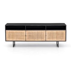 the sideboard is made out of rattan and black wood, with two drawers