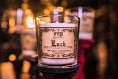 a close up of a candle on a table with other candles in the back ground