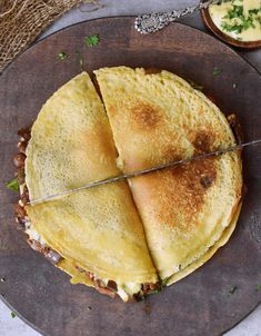 a pancake cut in half on top of a wooden plate