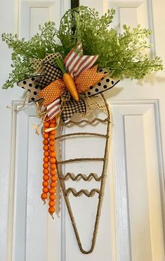 a door hanger decorated with carrots and greens