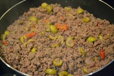 meat and vegetables cooking in a pan on the stove