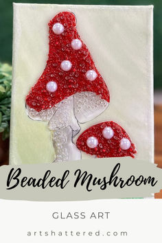 an art project with beads on it and the words beaded mushroom in white letters