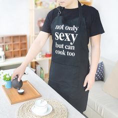 a woman in an apron is preparing food on a table with a teapot and saucer