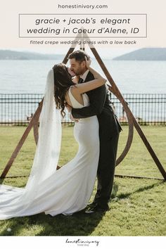 a bride and groom kissing in front of an arch with the words grace + jacob's elegant wedding in coeur d'alene, id