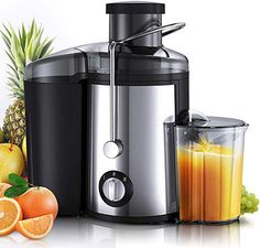 an image of a juicer with fruit and oranges on the table next to it