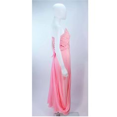 Description: Arnold Scaasi pink draped chiffon gown The bodice has a criss-cross design The skirt features a drape style Center back zipper closure with bow accent In very good condition with some minor fading Length: 52.5" Bust: 31" Waist: 28" Hip: 38" Details: Size: 4/6Color: PinkMaterial: ChiffonCondition: Very GoodShipping: All orders are shipped with a standard flat rate of $9.95 or expedited flat rate of $19.95. Pink Pre-draped Floor-length Evening Dress, Pink Sheer Evening Dress For Formal Occasions, Pink Sheer Evening Dress For Formal Events, Pink Sheer Evening Dress For Prom, Formal Pink Sheer Evening Dress, Pink Gown With Sheer Bodice For Evening, Pink Floor-length Evening Dress With Sheer Details, Pink Floor-length Sheer Evening Dress, Pink Sheer Floor-length Evening Dress