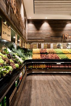 a grocery store filled with lots of fresh fruits and veggies on display next to each other