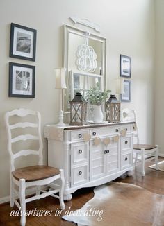 a white dresser and chair in a room