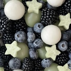 an assortment of soaps and berries are arranged in the shape of stars, snowflakes, and moon shapes