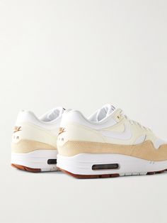 Nike's classic 'Air Max 1 SC' sneakers, designed by Tinker Hatfield, have been a consistent best-seller since they debuted in 1990. Updated in a fresh 'Sail', 'White Coconut Milk' and 'Light British Tan' colourway, this mesh version is panelled with leather and suede and has signature visible Air-Sole units in the heels. Leather Sneakers Men, Tinker Hatfield, Nike Classic, Nike Air Max 1, Latest Sneakers, Air Max 1, Suede Sneakers, Suede Jacket, Weekender Bag