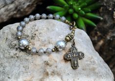 Handmade rosary bracelet made with natural shell pearl beads, electroplate crystal beads8mm, findings and religious charms. Jesus 4 ways cross religious charms bronze color. Please check out our SHOP POLICY and SHOP ANNOUNCEMENT before you make any payment, thank you. http://www.etsy.com/shop/rbckcreations/policy Thanks for taking a look and stopping by my shop! Spiritual Rosary Bracelet With 8mm Beads And Cross, Spiritual Rosary Bracelet With Cross For First Communion, Adjustable Purple Beaded Rosary Bracelet, Handmade Adjustable Purple Rosary, Cross-shaped Rosary Bracelet With 8mm Beads, Silver Cross-shaped Rosary Bracelet With 8mm Beads, Brown Cross-shaped Rosary With Wooden Beads, Rosary Bracelet, Saints Medals