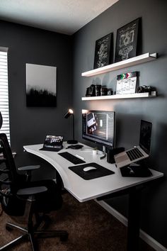 a desk with a laptop and monitor on it