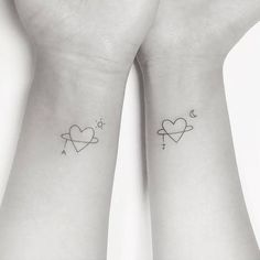 two wrist tattoos with hearts and stars on each side of the wrists, one has an arrow in the shape of a heart