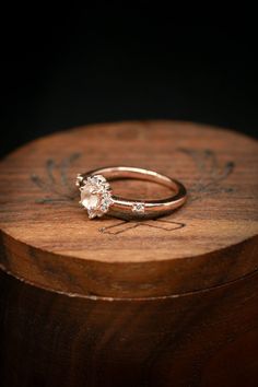 a close up of a ring on top of a wooden box