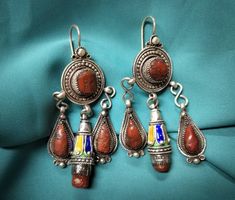 Magnificent kabyle earrings in sterling silver enamelled with blue, green and yellow color, inlaid with two cabochon of real coral. **Height: 7.6 cm. **Width: 3.7 cm. **Material: sterling silver 925, real coral. **Weight: 35.4 grams. **Origin: great Kabyle region 1970s - Algeria. **Shipping: free worldwide by DHL. I am always open to offers for one of my items, so please contact me if you would like to make an offer. Do not hesitate to contact me for any questions. All items advertised for sale Artisan Filigree Jewelry For Festivals, Traditional Multicolor Sterling Silver Earrings, Ornate Dangle Jewelry For Festivals, Traditional Sterling Silver Earrings For Festivals, Multicolor Pendant Earrings For Festivals, Traditional Enamel Pendant Jewelry, Traditional Turquoise Filigree Jewelry, Traditional Turquoise Jewelry With Filigree, Traditional Multicolor Nickel-free Jewelry