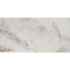 a white marble counter top with gold veining