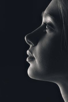 a black and white photo of a woman's profile with her nose slightly open