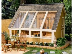 a small wooden house sitting on top of a lush green field