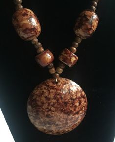 "Brown and beige marbled resin statement necklace. The central pendant is 2.75\" and it's surrounded by matching beads of different shapes and sizes. Very earthy, organic career look, but also works with jeans. Measures 20\" long. Also, please take a look at my storefront at: https://www.etsy.com/shop/FabFinds42?ref=seller-platform-mcnav I have a wide selection of one-of-a-kind items, from clothing and toys to home decor and gift items, and I add new things almost every day." Unique Brown Resin Necklaces, Handmade Brown Resin Jewelry, Unique Brown Beaded Round Necklace, Unique Brown Beaded Necklaces, Unique Brown Beaded Round Necklaces, Bohemian Resin Round Pendant Necklace, Marbled Resin, Fall Necklace, Autumn Necklace