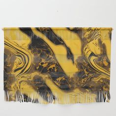 a yellow and black scarf hanging on a wall