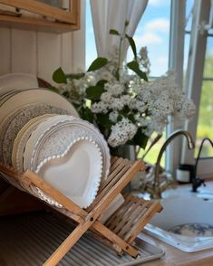 a stack of plates sitting on top of a wooden tray