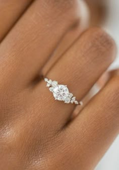 a woman's hand with a diamond ring on it