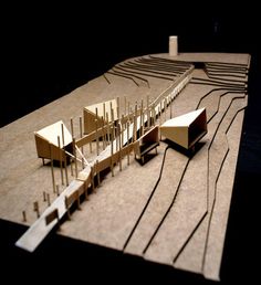 an architectural model of a building made out of wood sticks and plexed paper