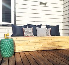 a wooden bench sitting on top of a wooden deck