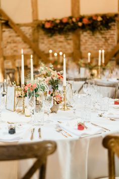 the table is set with candles and place settings