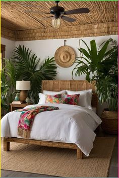 a bed with white sheets and pillows in a room with palm trees on the wall