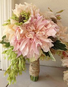 a wedding bouquet with pink and green flowers