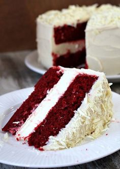 a slice of red velvet cake with white frosting