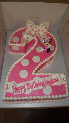 a birthday cake in the shape of a number two with minnie mouse and polka dots